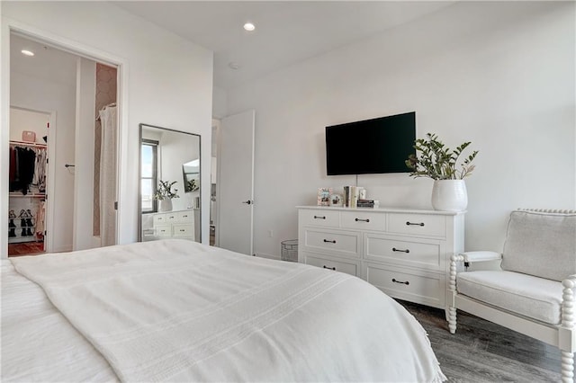 800 Embassy Dr Unit 319, Austin, TX 78702 - bedroom featuring dark wood finished floors, a walk in closet, and recessed lighting