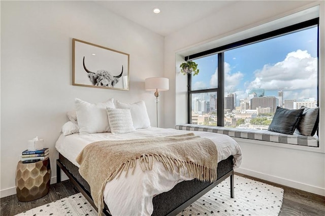 800 Embassy Dr Unit 319, Austin, TX 78702 - bedroom with baseboards, a view of city, wood finished floors, and recessed lighting