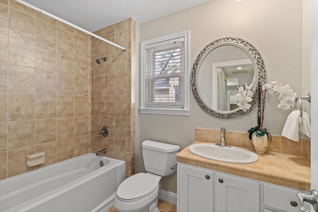 full bathroom with toilet, visible vents, vanity, baseboards, and shower / bathing tub combination