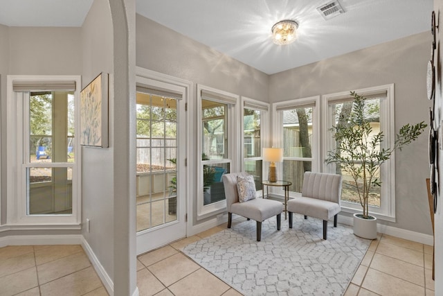 sunroom featuring a healthy amount of sunlight and visible vents