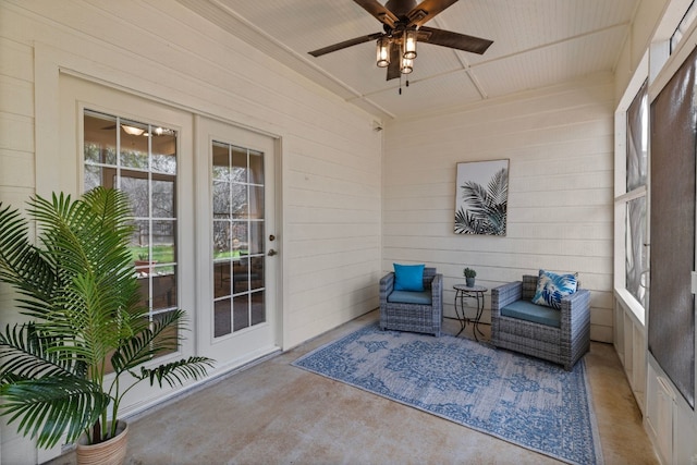 sunroom / solarium featuring ceiling fan