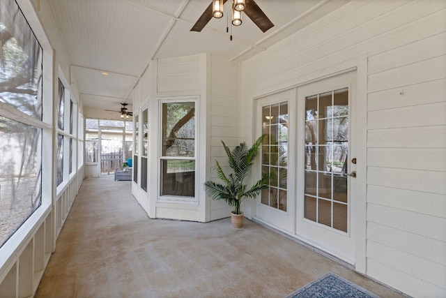 unfurnished sunroom featuring french doors and ceiling fan