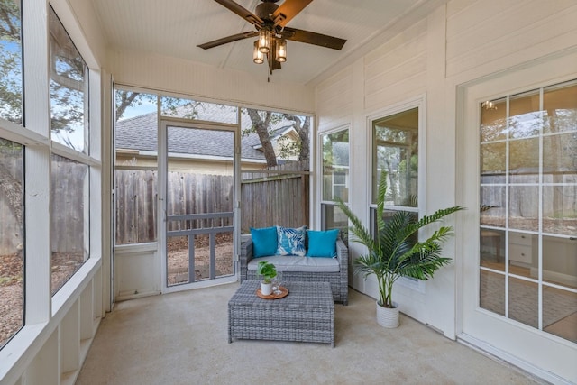 unfurnished sunroom with a ceiling fan