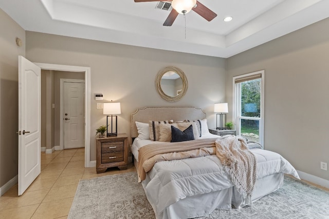 bedroom featuring light tile patterned floors, baseboards, visible vents, a raised ceiling, and recessed lighting