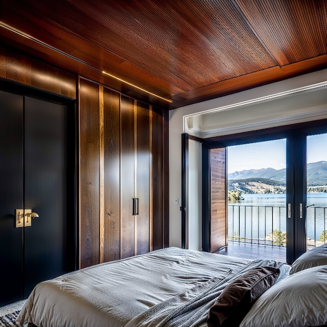 bedroom featuring access to outside, wooden ceiling, and a water and mountain view