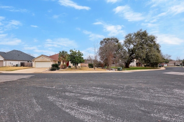 view of street with a residential view, curbs, and sidewalks