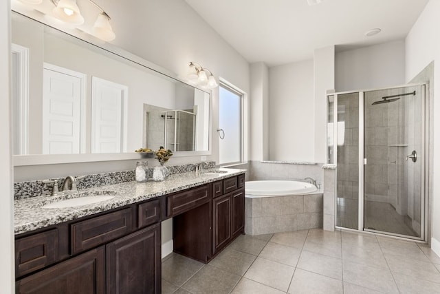 bathroom with tile patterned flooring, a garden tub, a sink, and a shower stall