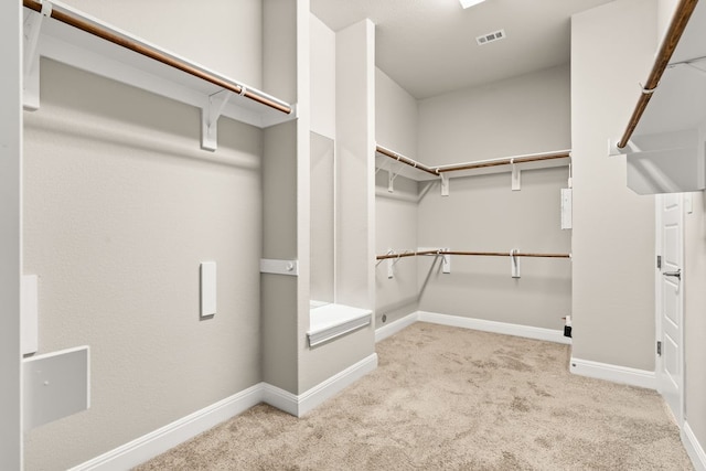 spacious closet with light carpet and visible vents