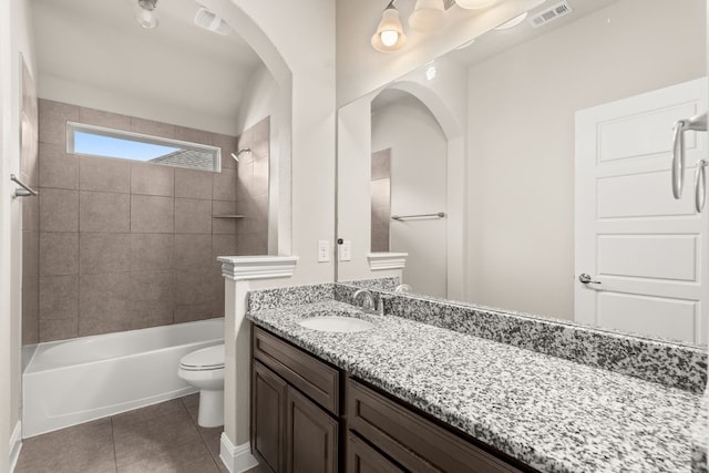 bathroom featuring bathtub / shower combination, toilet, vanity, visible vents, and tile patterned floors