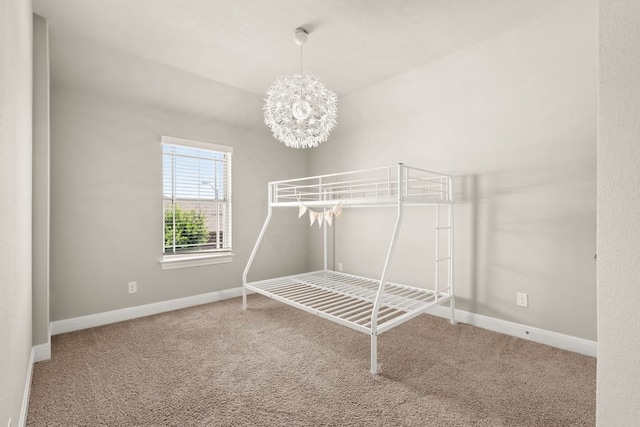 walk in closet with carpet and an inviting chandelier