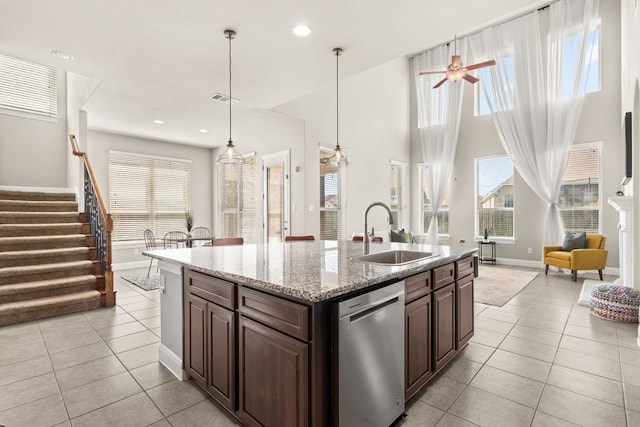 3809 Alpine Ridge Cv, Leander, TX 78641 - kitchen featuring dishwasher, light tile patterned floors, a center island with sink, light stone counters, and recessed lighting