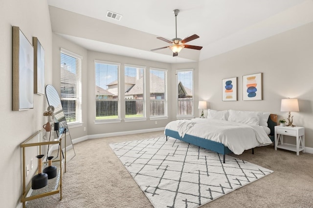 bedroom featuring light carpet, ceiling fan, visible vents, and baseboards