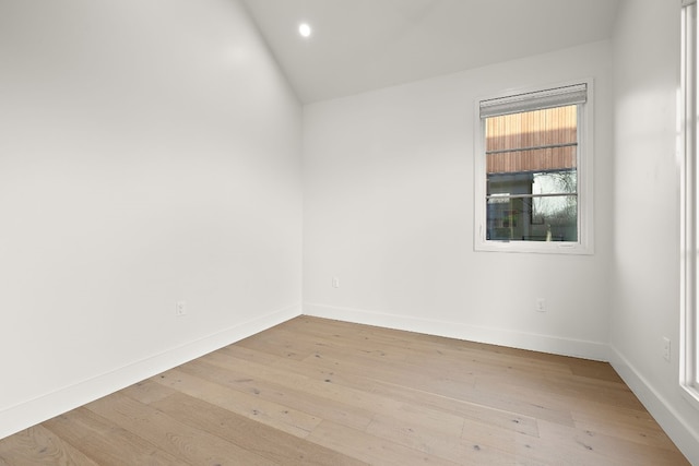 unfurnished room with light wood-type flooring, baseboards, vaulted ceiling, and recessed lighting