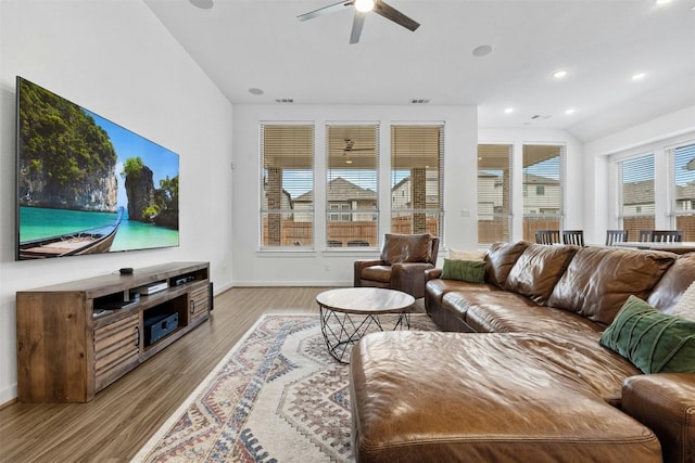 living area with baseboards, a ceiling fan, light wood finished floors, and recessed lighting