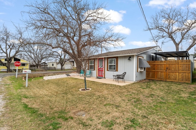 exterior space with a patio, a yard, and fence