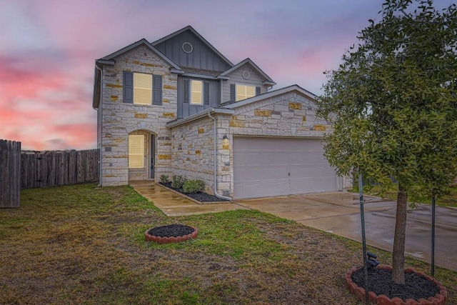 traditional-style house with concrete driveway, an attached garage, fence, a front lawn, and board and batten siding