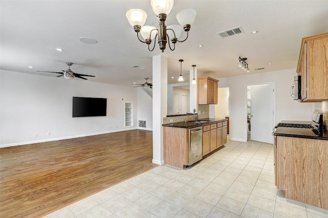 5006 Daymon Ct, Hutto, TX 78634 - kitchen with appliances with stainless steel finishes, a ceiling fan, recessed lighting, light wood-style flooring, and decorative light fixtures
