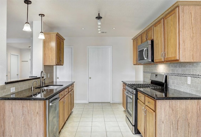 5006 Daymon Ct, Hutto, TX 78634 - kitchen featuring stainless steel appliances, dark stone countertops, tasteful backsplash, and light tile patterned floors