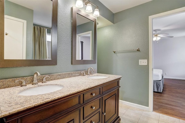 5006 Daymon Ct, Hutto, TX 78634 - bathroom with double vanity, tile patterned flooring, a ceiling fan, and a textured wall