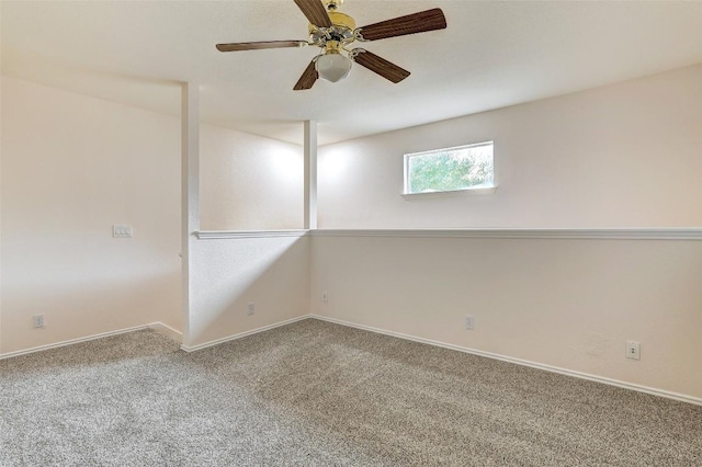 empty room featuring carpet, baseboards, and ceiling fan