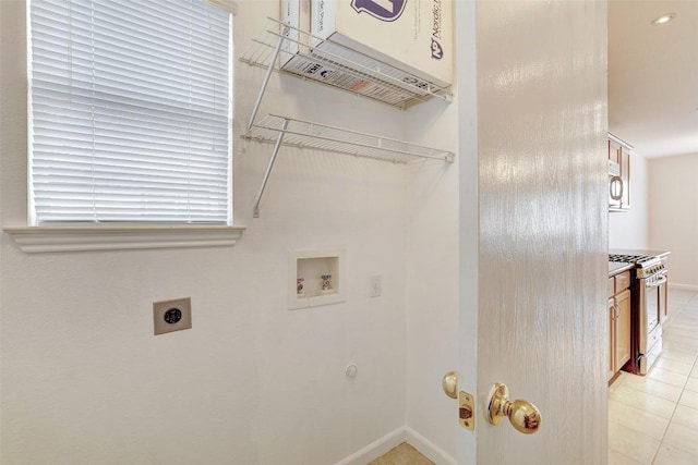 5006 Daymon Ct, Hutto, TX 78634 - laundry room with hookup for an electric dryer, washer hookup, and light tile patterned floors