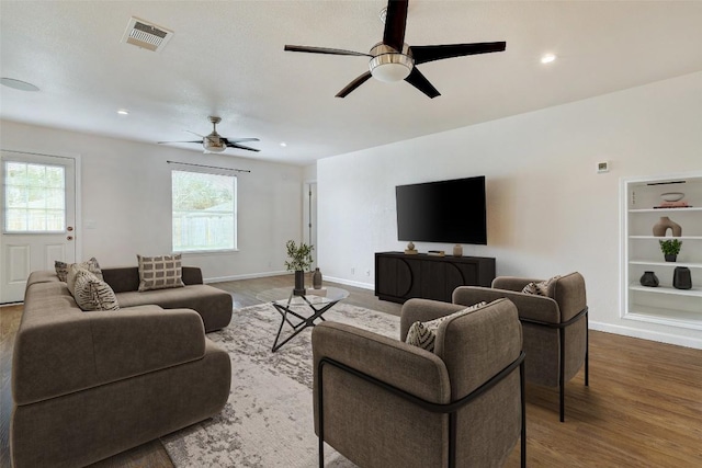 5006 Daymon Ct, Hutto, TX 78634 - living room featuring a ceiling fan, wood finished floors, baseboards, recessed lighting, and built in features