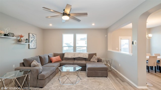 6205 Conestoga Wagon Way, Del Valle, TX 78617 - living area with light wood-style flooring, arched walkways, a ceiling fan, recessed lighting, and baseboards