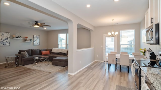 6205 Conestoga Wagon Way, Del Valle, TX 78617 - living area with light wood finished floors, baseboards, a chandelier, recessed lighting, and a ceiling fan
