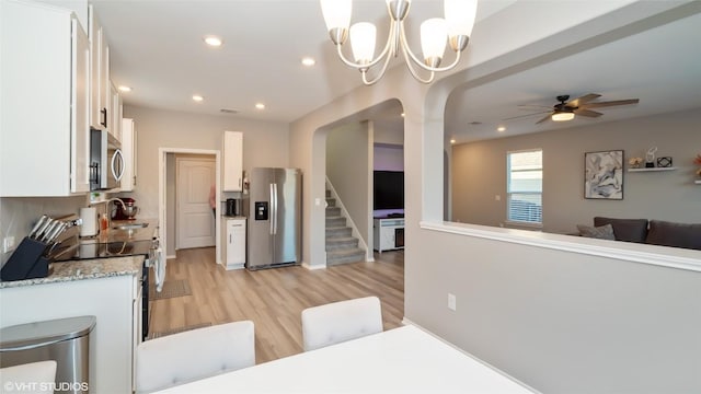 6205 Conestoga Wagon Way, Del Valle, TX 78617 - kitchen with appliances with stainless steel finishes, white cabinetry, a sink, light wood-style floors, and recessed lighting
