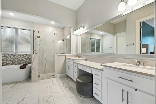 full bath featuring marble finish floor, a sink, a marble finish shower, and double vanity