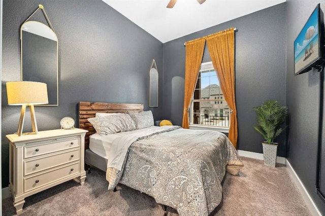 bedroom with a ceiling fan, lofted ceiling, dark carpet, and baseboards