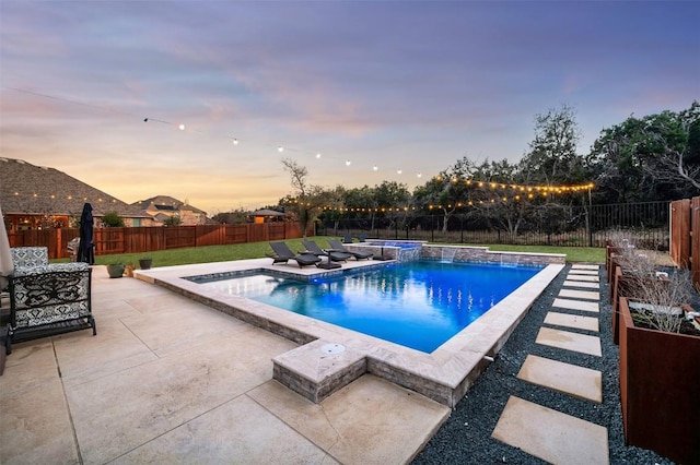 pool at dusk with a fenced in pool, a patio area, a fenced backyard, and a jacuzzi