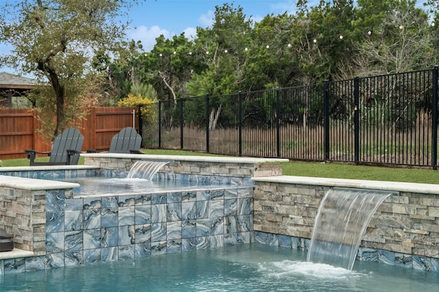 view of swimming pool featuring fence