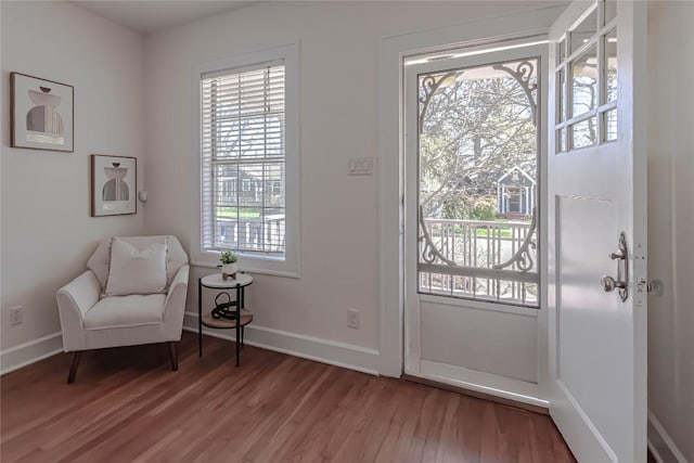 interior space featuring baseboards and wood finished floors