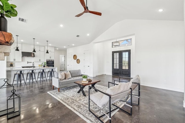 living area with baseboards, visible vents, a ceiling fan, and french doors