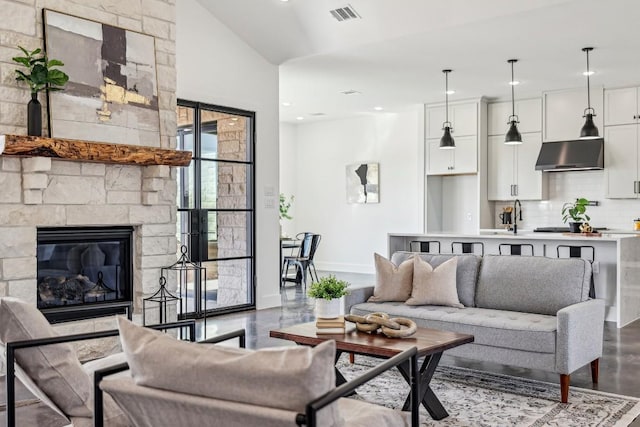 living area with recessed lighting, visible vents, a fireplace, and baseboards