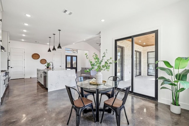 dining room featuring finished concrete flooring, visible vents, vaulted ceiling, french doors, and recessed lighting