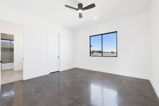 spare room featuring concrete floors, baseboards, a ceiling fan, and recessed lighting