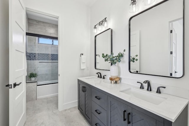 bathroom with combined bath / shower with glass door, a sink, baseboards, and double vanity