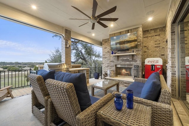 view of patio featuring an outdoor brick fireplace, a grill, and ceiling fan