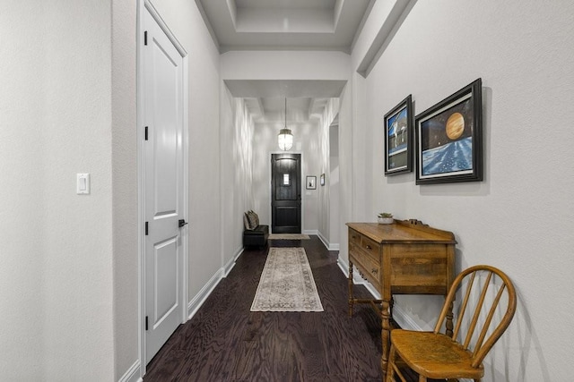 doorway to outside with baseboards and dark wood-type flooring