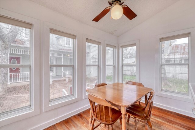 sunroom / solarium featuring lofted ceiling and ceiling fan