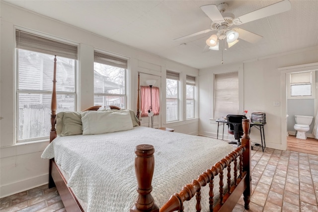 bedroom with multiple windows, a ceiling fan, and baseboards
