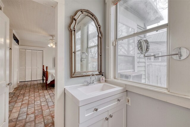 bathroom featuring brick floor, a ceiling fan, and vanity