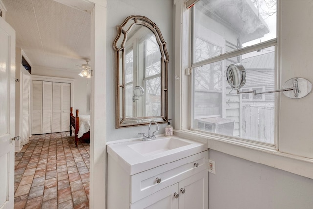 bathroom featuring brick floor, vanity, and a ceiling fan