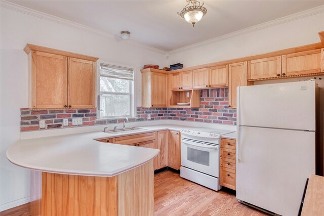 kitchen with white appliances, light brown cabinets, light countertops, and a sink