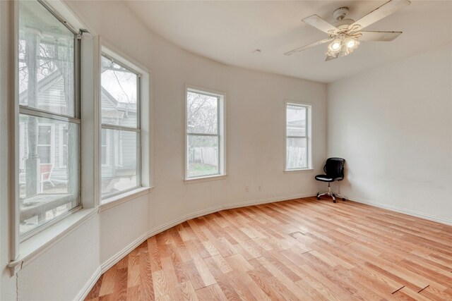 unfurnished room with light wood-style flooring, baseboards, and ceiling fan