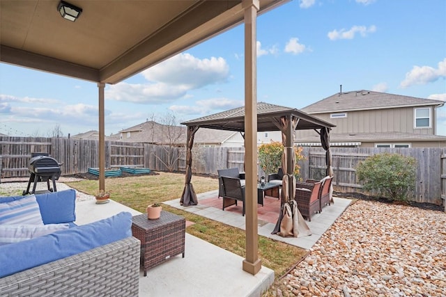 view of patio / terrace featuring a fenced backyard, an outdoor living space, and a gazebo