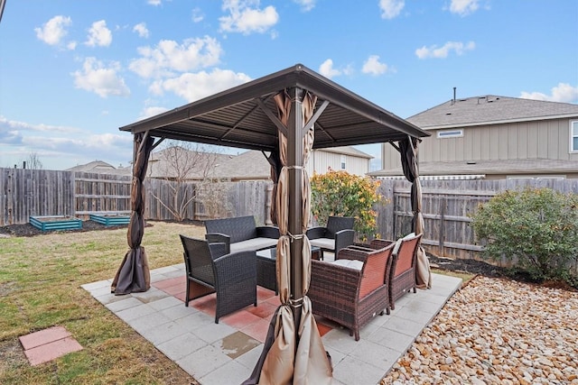 view of patio / terrace featuring a fenced backyard, an outdoor living space, and a gazebo