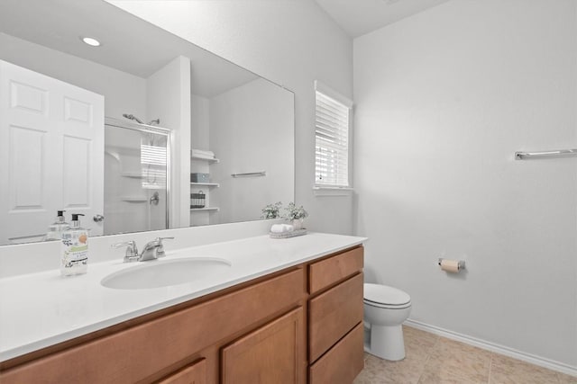 full bath featuring toilet, a shower stall, vanity, baseboards, and tile patterned floors